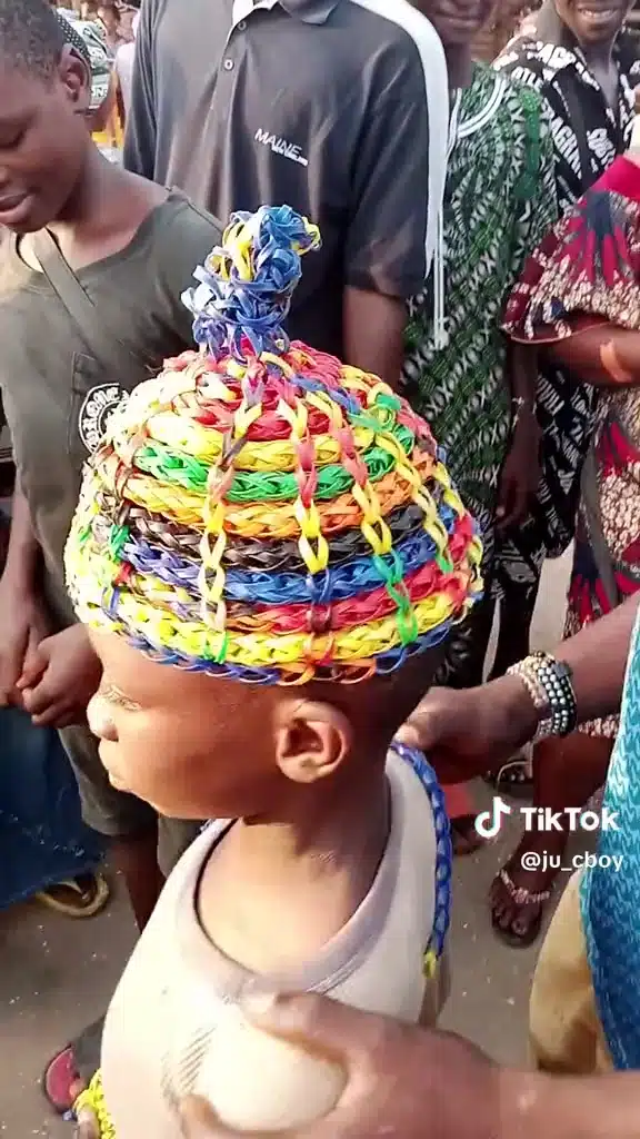 Nigerian boy makes hats and shoes with straw